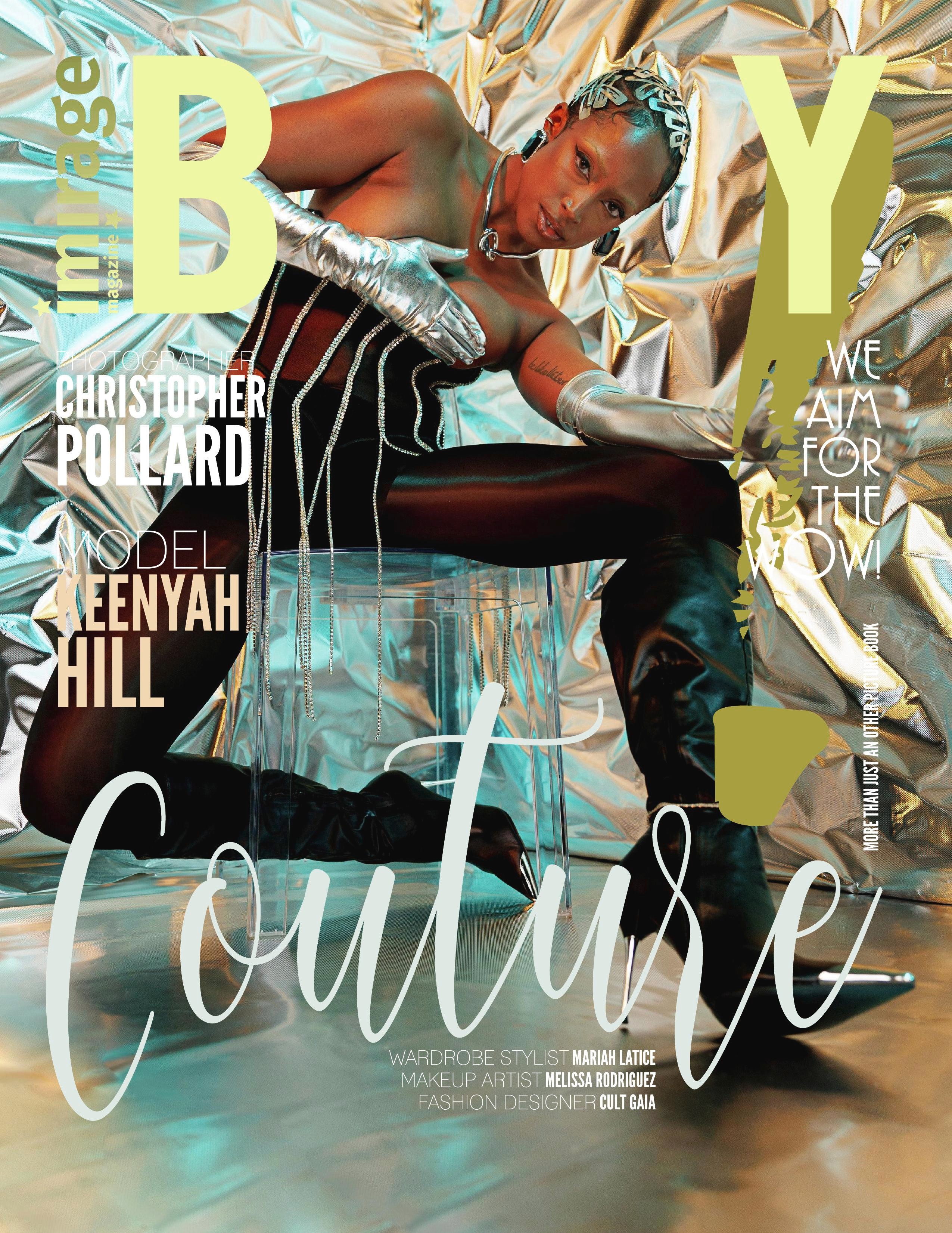 Person in metallic outfit and gloves, sitting on a reflective surface with a shiny background, holding a glass container.