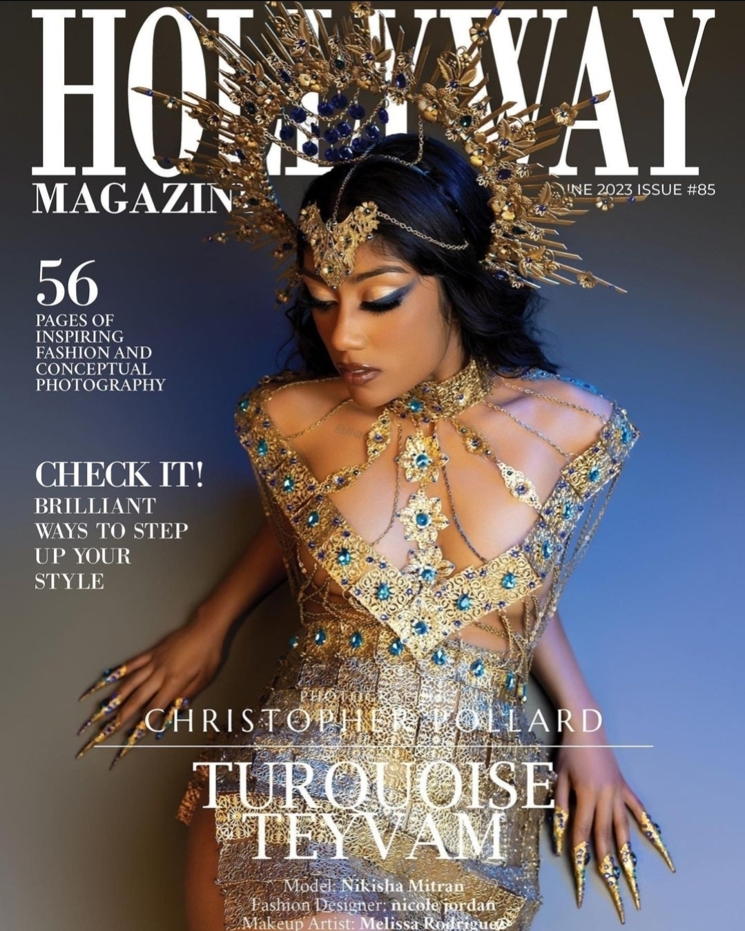 Woman in ornate gold and blue costume with elaborate headpiece and jewelry, posing against a dark background.