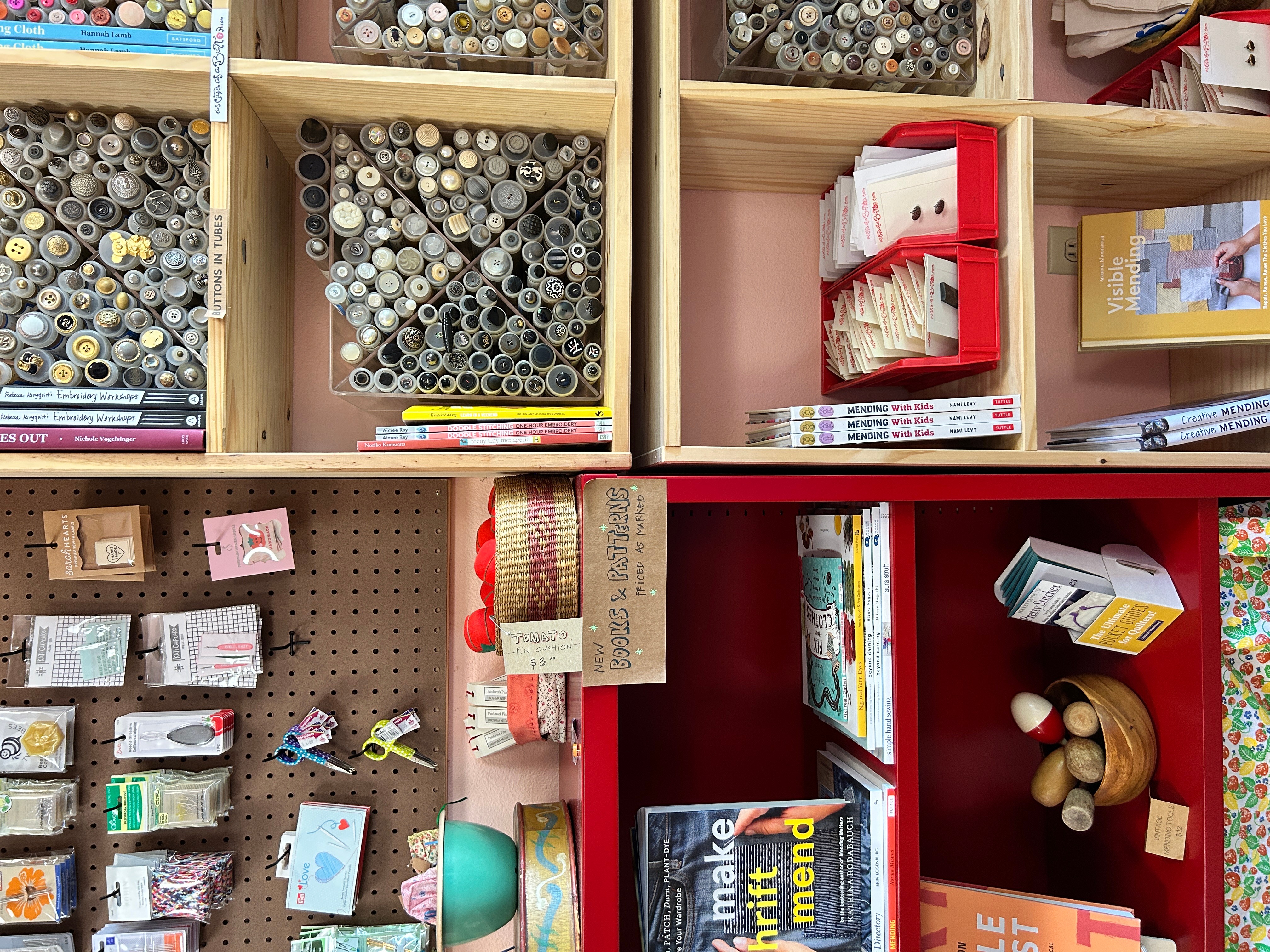 Shelves with art supplies, books, and craft items, including markers, paper, and a teddy bear, organized in compartments.