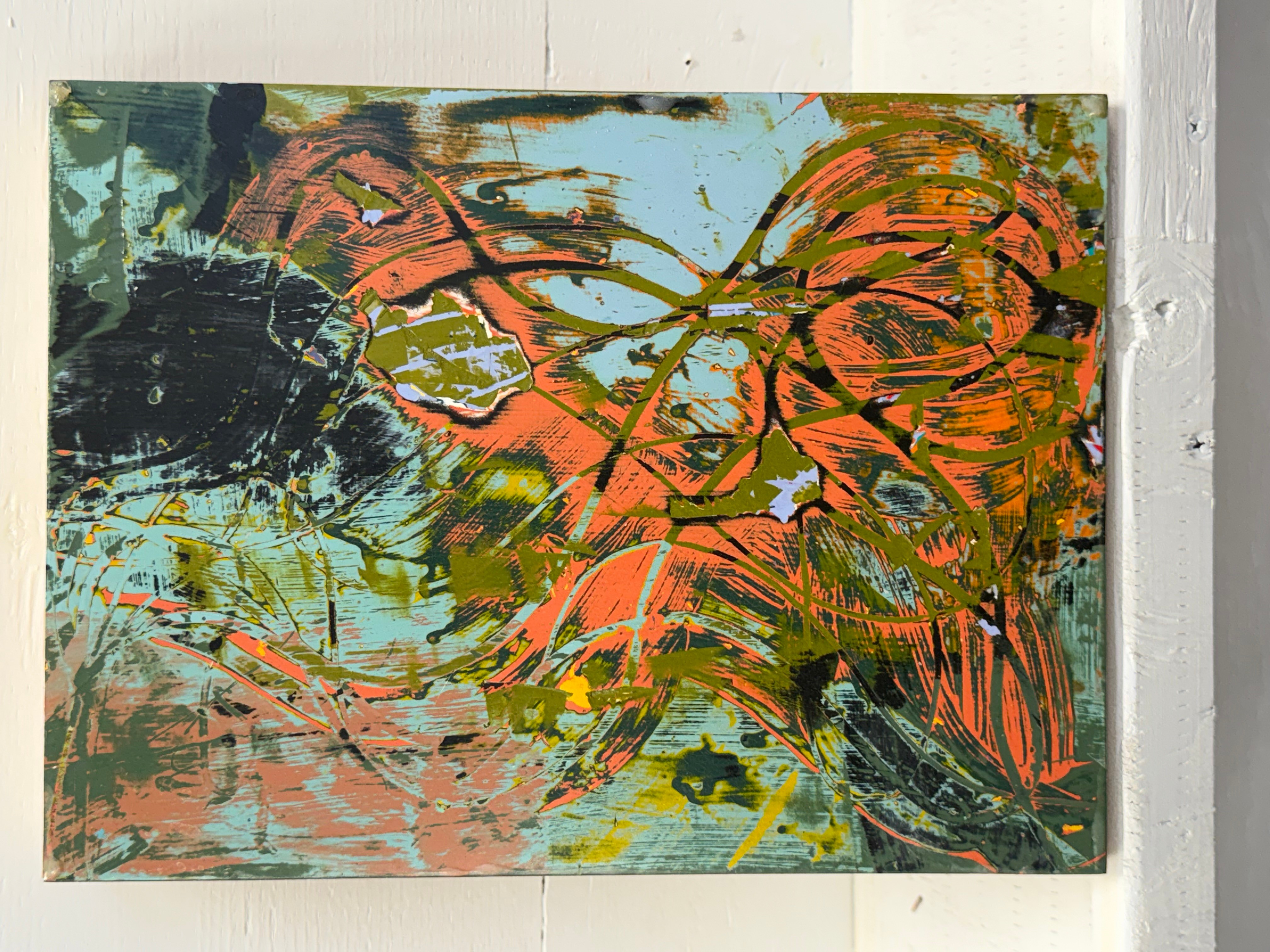 Abstract painting with orange, green, black, and blue brushstrokes and shapes on a canvas.