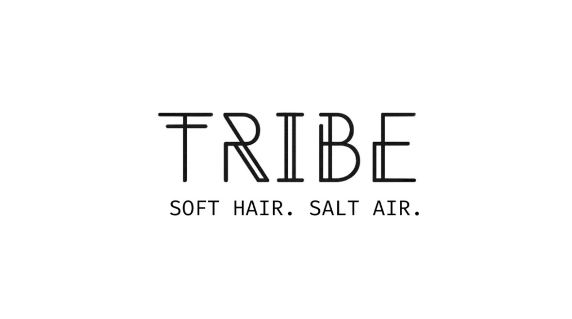 Text logo with the word 'TRIBE' and the phrase 'SOFT HAIR. SALT AIR.' beneath it.